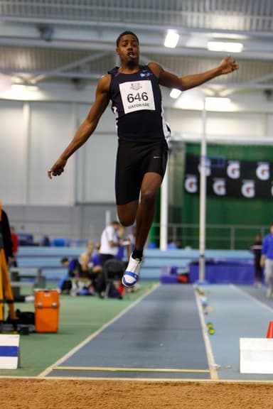 Andre competing in an indoor long jump national final