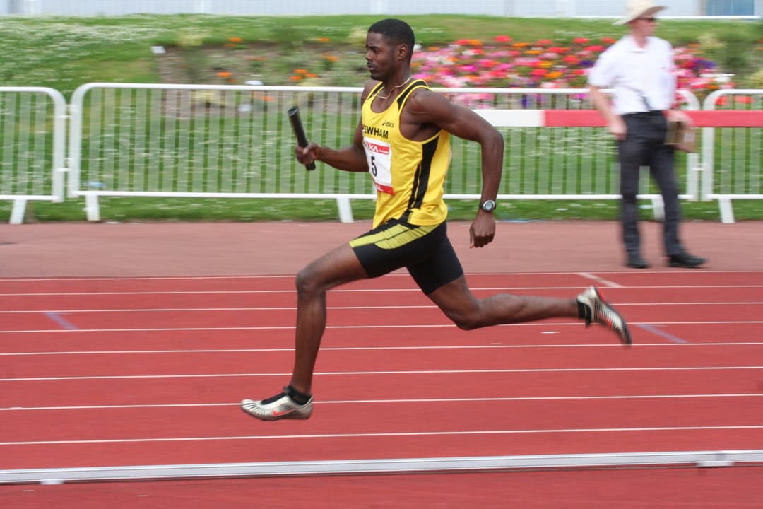 Andre racing the final leg of a relay in Newham colours
